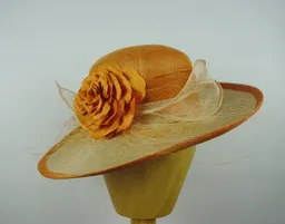 Upswept hat in sinamay and parisisal straw with silk flower and sinamay trim.