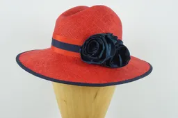 Brilliant red parasisal straw with a flattering crown shape and navy silk rose detail.