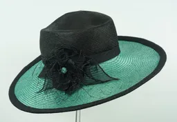 Wide brimmed black and emerald parasisal straw featuring stitched wild silk flower and ribbon trim.